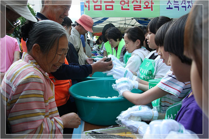 Юнг Хянджа, председатель Центра труда и занятости Кванджу, вместе с волонтёрами делает рисовые шарики.
